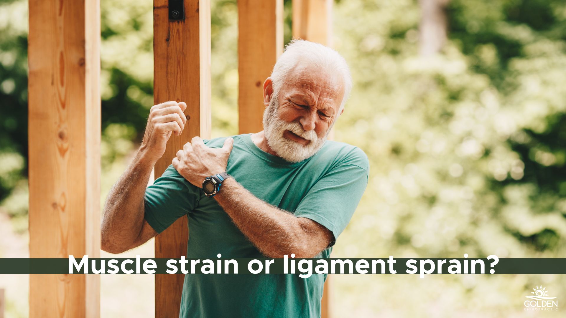 Older man standing in front of house scaffolding clutching his shoulder in pain